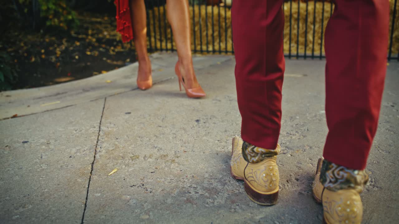 Couple in stylish shoes on concrete
