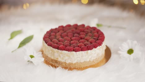 cheesecake garnished with raspberries on the table