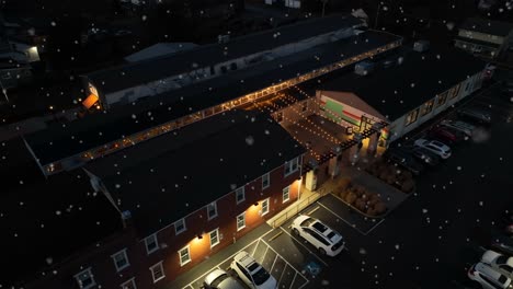 Cars-at-apartment-building-at-night-during-winter-snowstorm