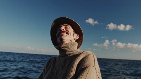 smiling senior man enjoying the view by the ocean