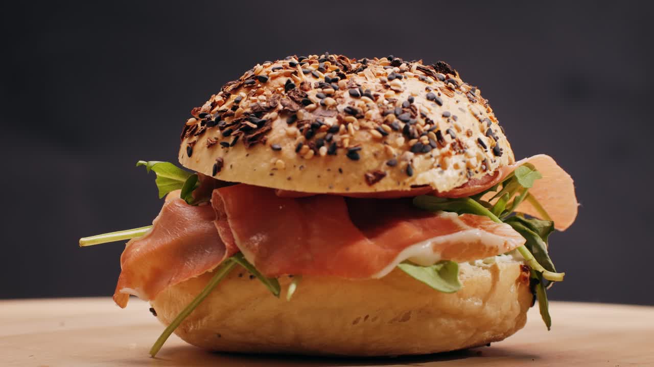 Bagel sandwich brunch, lunch plate of a bagel with smoked salmon and cream cheese and ham, close up morning cafe menu.