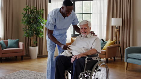 caregiver assists elderly man in wheelchair with a blanket
