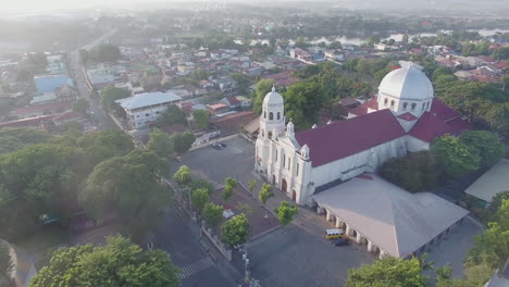 a glowing shiny majestic landscape drone view of a basilica church of the city having river and mountains, batangas, philippines