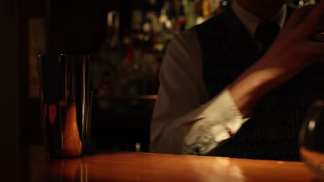 bartender skillfully using a cocktail shaker at bar