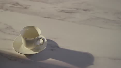 Studio-Shot-Of-Person-Making-And-Traditional-British-Cup-Of-Tea-Using-Teapot