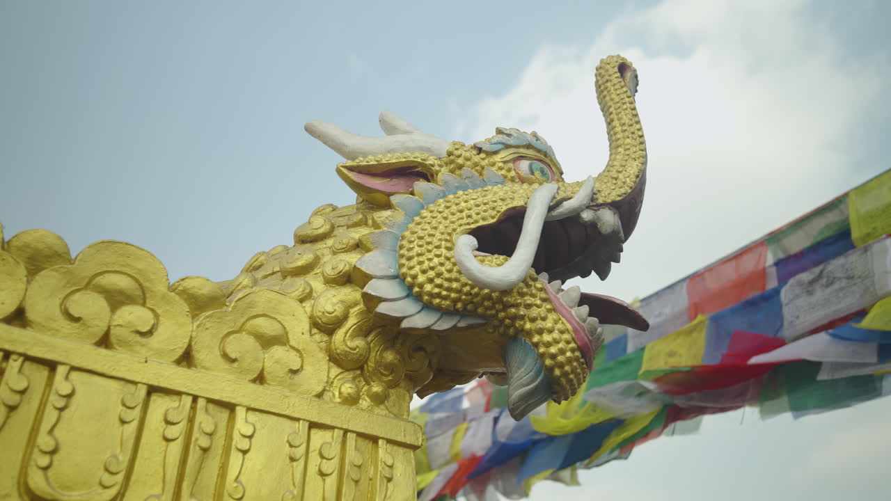 Closeup of a tiger statue at a Buddhist stupa in Nepal. Prayer flags flutter in the background, revealing the site’s spiritual symbolism, sacred architecture, and cultural significance