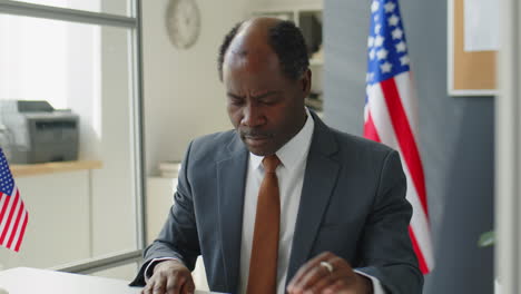 businessman reviewing passport in office