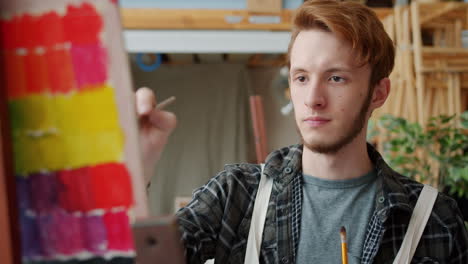 young artist painting in studio