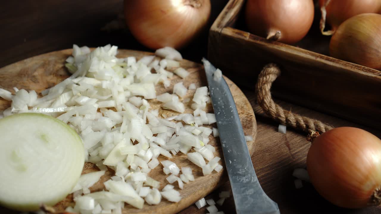 The pieces of onion on a cutting Board with a knife.
