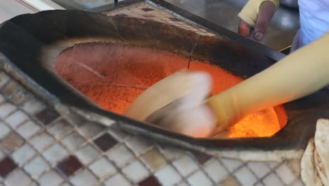 baking bread in a hot tandoor oven