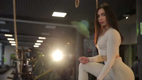 woman working out in gym with dumbbells