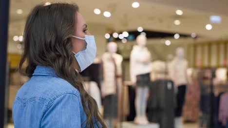 Video-of-woman-in-protective-mask-in-shopping-mall