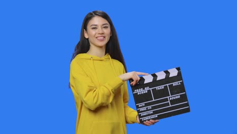 woman holding clapperboard