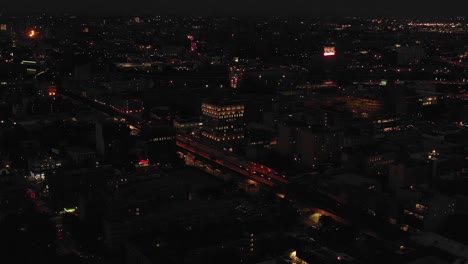 Short-stationary-drone-aerial-shot-of-Harlem,-NYC,-including-train-line,-at-twilight