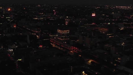 short stationary drone aerial shot of harlem, nyc, including train line, at twilight