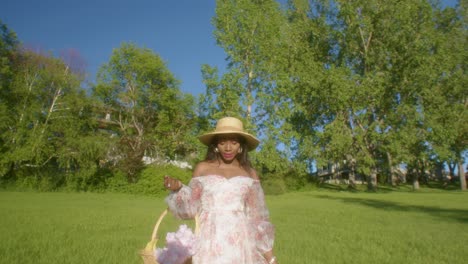 Black-Woman-looking-eye-contact-in-the-park-in-dress