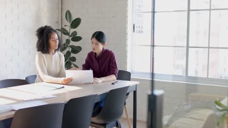 Busy-diverse-casual-businesswomen-at-table-discussing-project-in-office-in-slow-motion