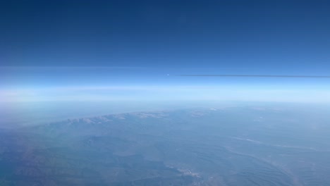 an airplane with a condensation strip flies beside a passenger airplane