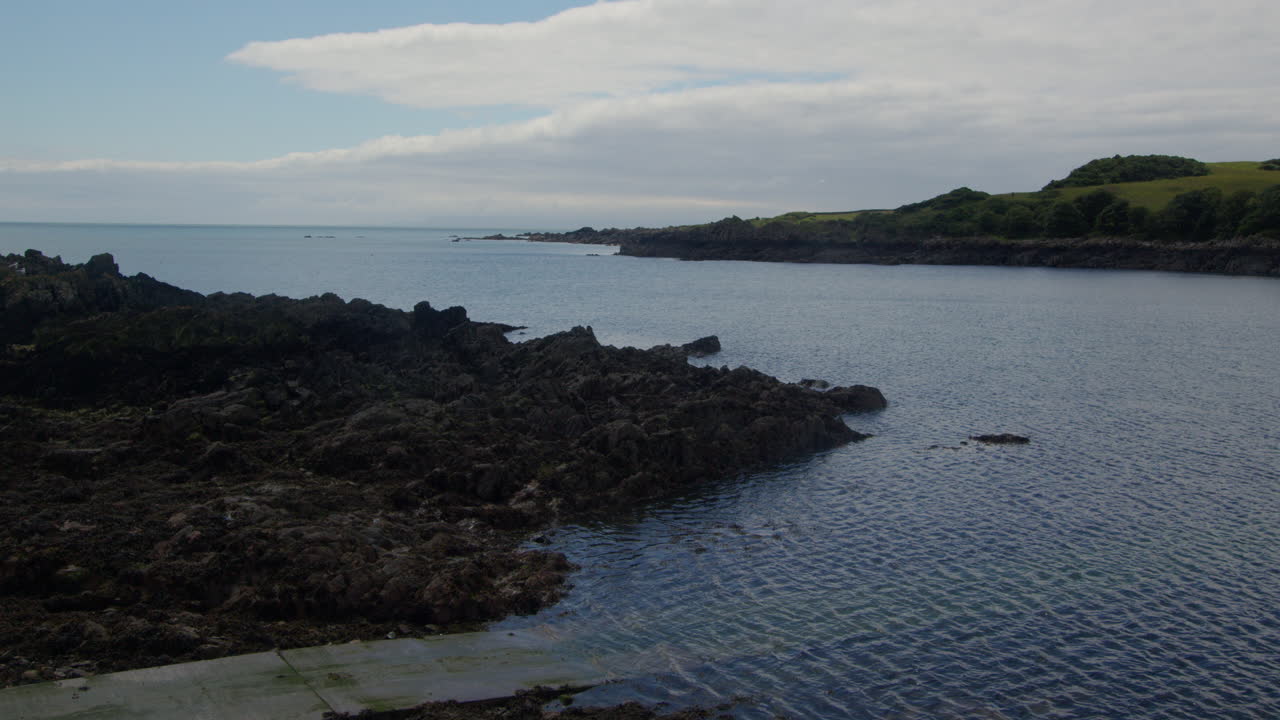 shot looking across the rocky entrance to Isle of Whithorn harbour at low tide
