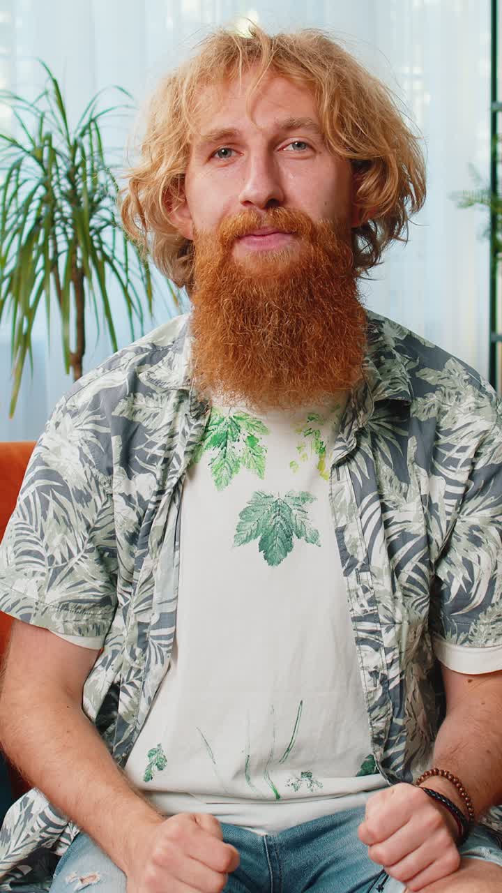 Happy caucasian man looking approvingly at camera showing thumbs up like positive sign good news