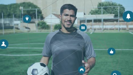 network of connections against portrait of male soccer player holding soccer ball on grass field