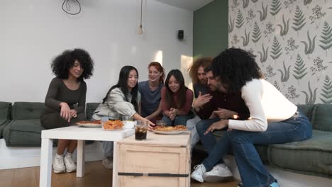 diverse friends cheering up for woman bringing pizzas during weekend party at home