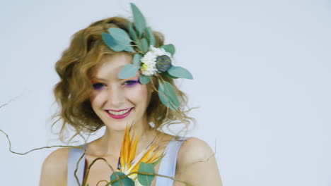 spring inspiration portrait of a girl with lotus flowers in her hair on a white background