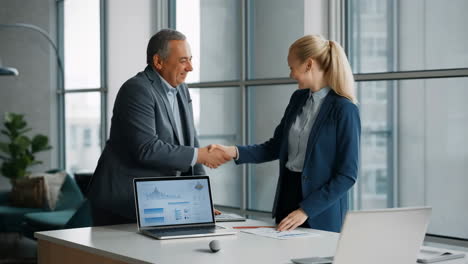 business professionals shaking hands in an office