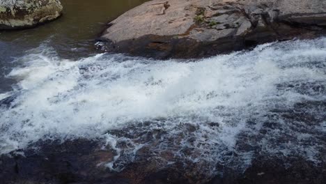 Lateral-camera-movement-filming-waterfall-and-then-camera-going-up-showing-trees-and-waterfall-water