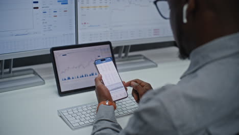 businessman analyzing stock market data on mobile phone