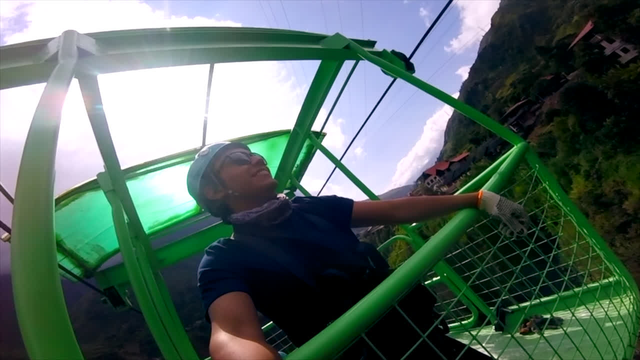 Close-up of young man in cable car at Ba&ntilde;os in Ecuador, selfie mode