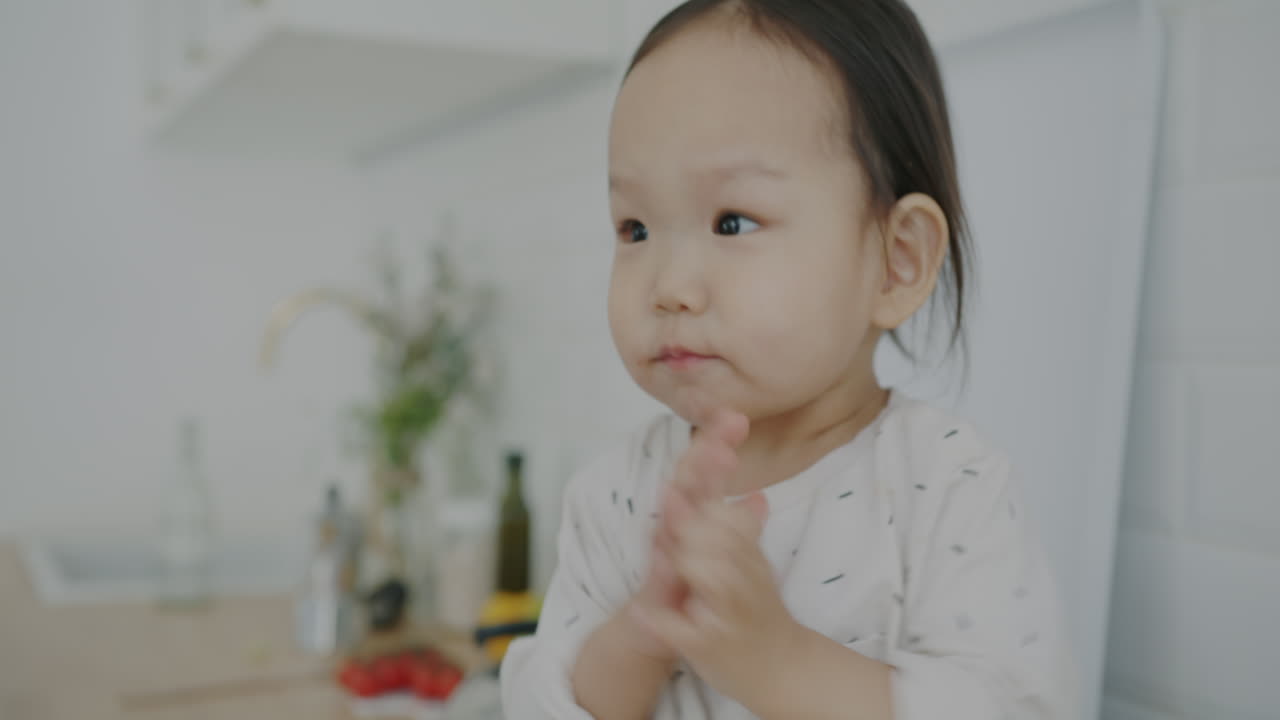 A happy toddler clapping hands