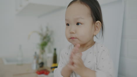 a happy toddler clapping hands