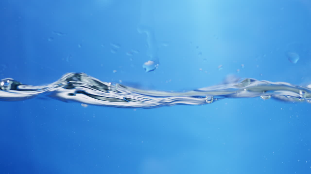 Slow motion of water waves on the surface with a blue background is suitable for product promotion