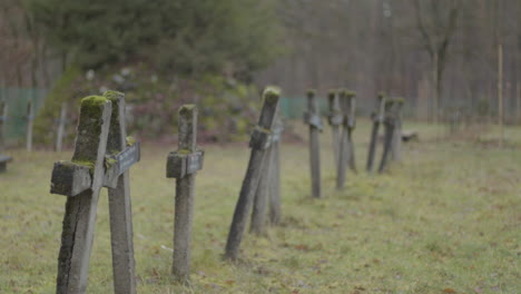 focus rack of old and crooked crosses at graveyard