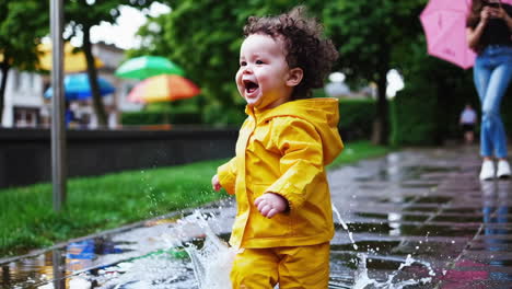 joyful toddler splashing in puddles