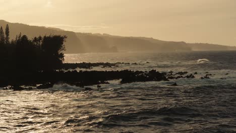 sunset over a volcanic coastline