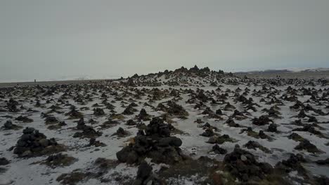 Laufskálavarða-Rock-Formations-Covered-in-Ice-and-Snow,-Aerial-Low-Drone-Dolly-Shot-in-Iceland