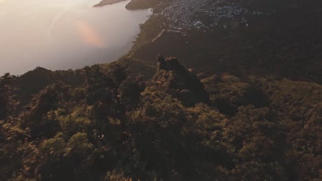 Fly-down-mountain-slope-in-Guatemala-during-golden-sunrise,-FPV