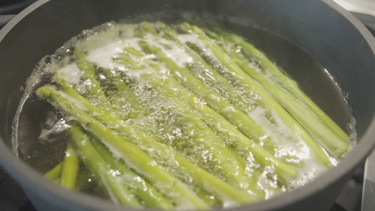 Green asparagus cooks in modern saucepan on induction plate, Healthy Eating, Vegetables