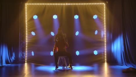 dynamic burlesque duo performance on stage with creative lighting