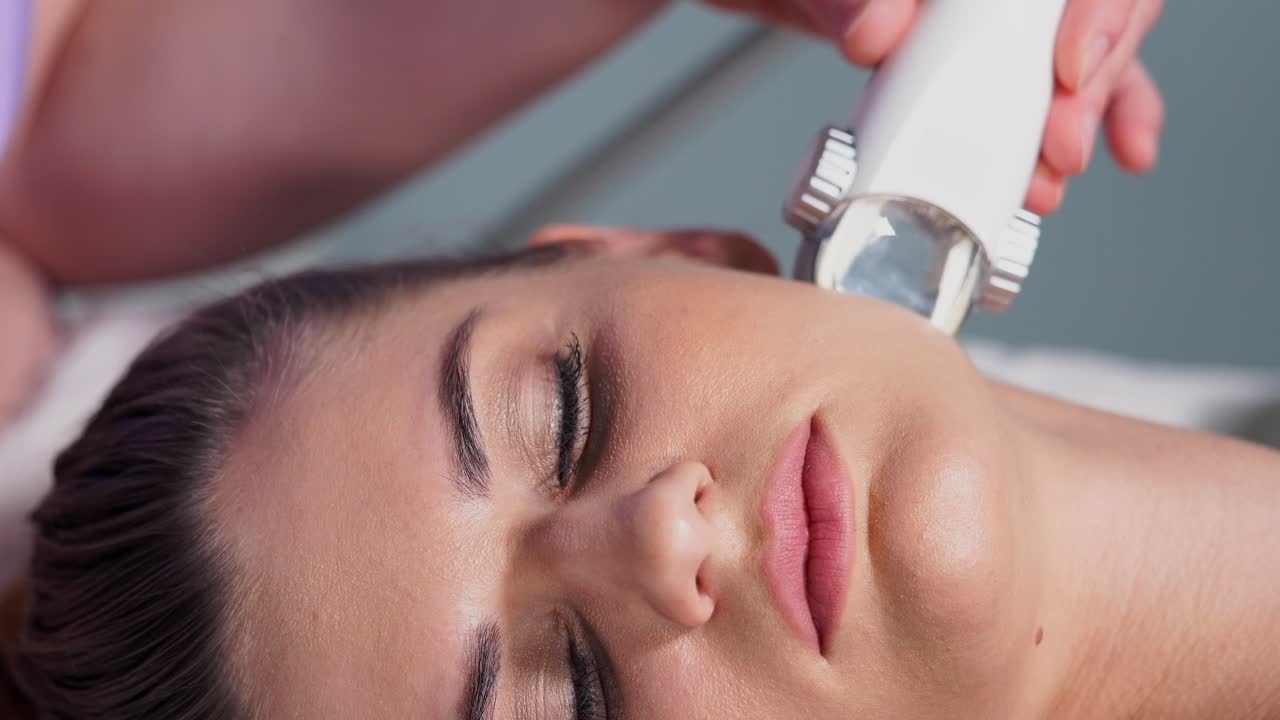 Woman receiving a facial treatment at a spa.