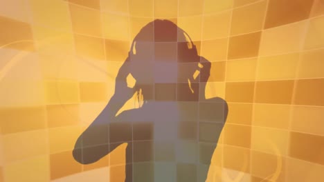 Animation-of-dj-wearing-headphones-silhouette-over-orange-and-brown-flashing-lights