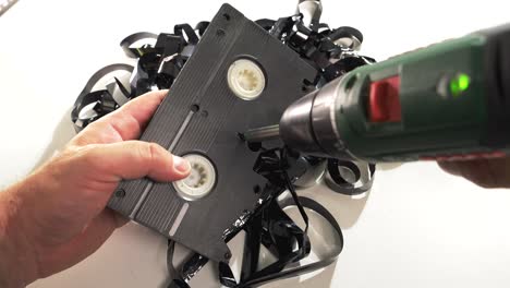 unwinding a vhs cassette using an electric screwdriver