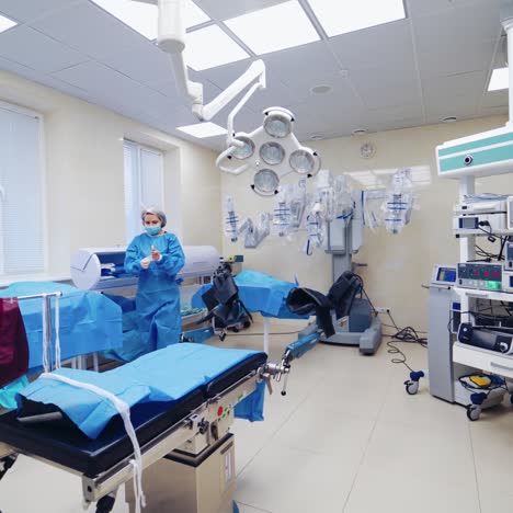 a view of a modern operating room with a medical professional and robotic surgical equipment