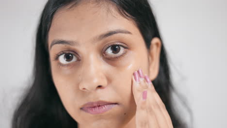 a young lady applying gel cream under eye for dark circle, insomnia, periorbital dark circle, close up shot.