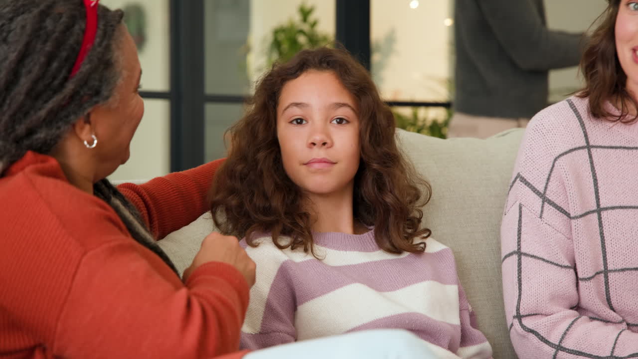 At Christmas, Diverse family enjoying cozy holiday moments together on couch at home