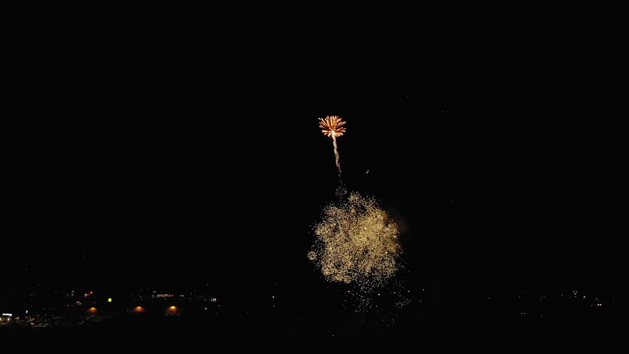 Aerial of Fireworks Over Small Town With Moon