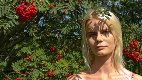 in summertime, a lady standing outside in the shadow of a flowery nature