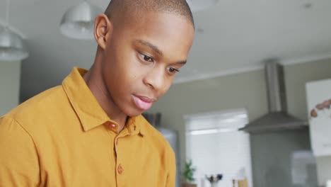 video of sad african american boy using smartphone at home